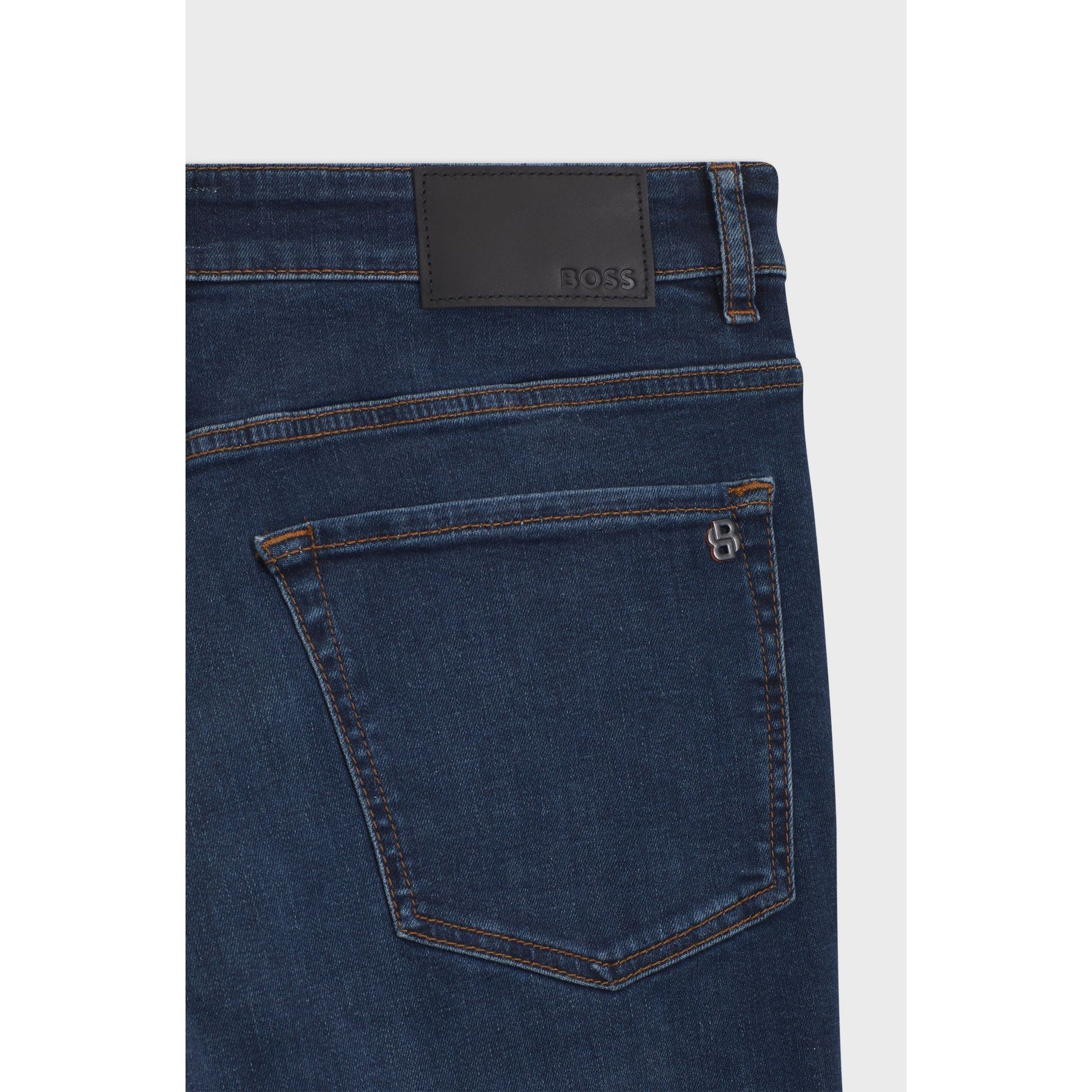 Close-up of a blue denim jeans with a visible brand label on a white background